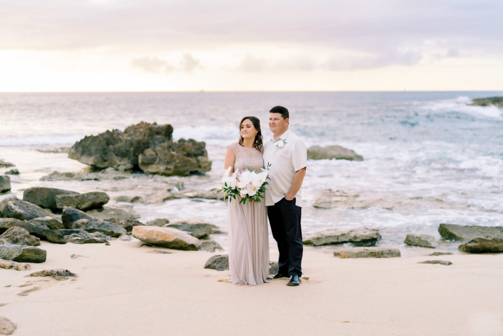 A bride and groom on the beach at the Four Seasons Resort Oahu, Hawaii