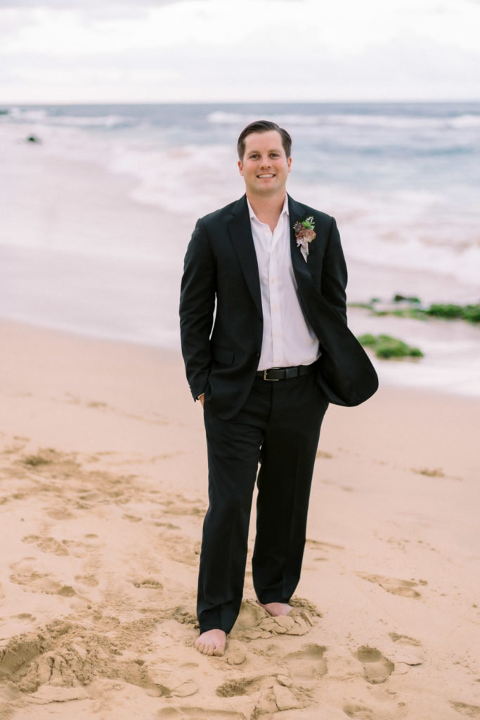 A recently married couple on Sandy beach, photos taken by wedding photographer in Hawaii, Megan Moura.