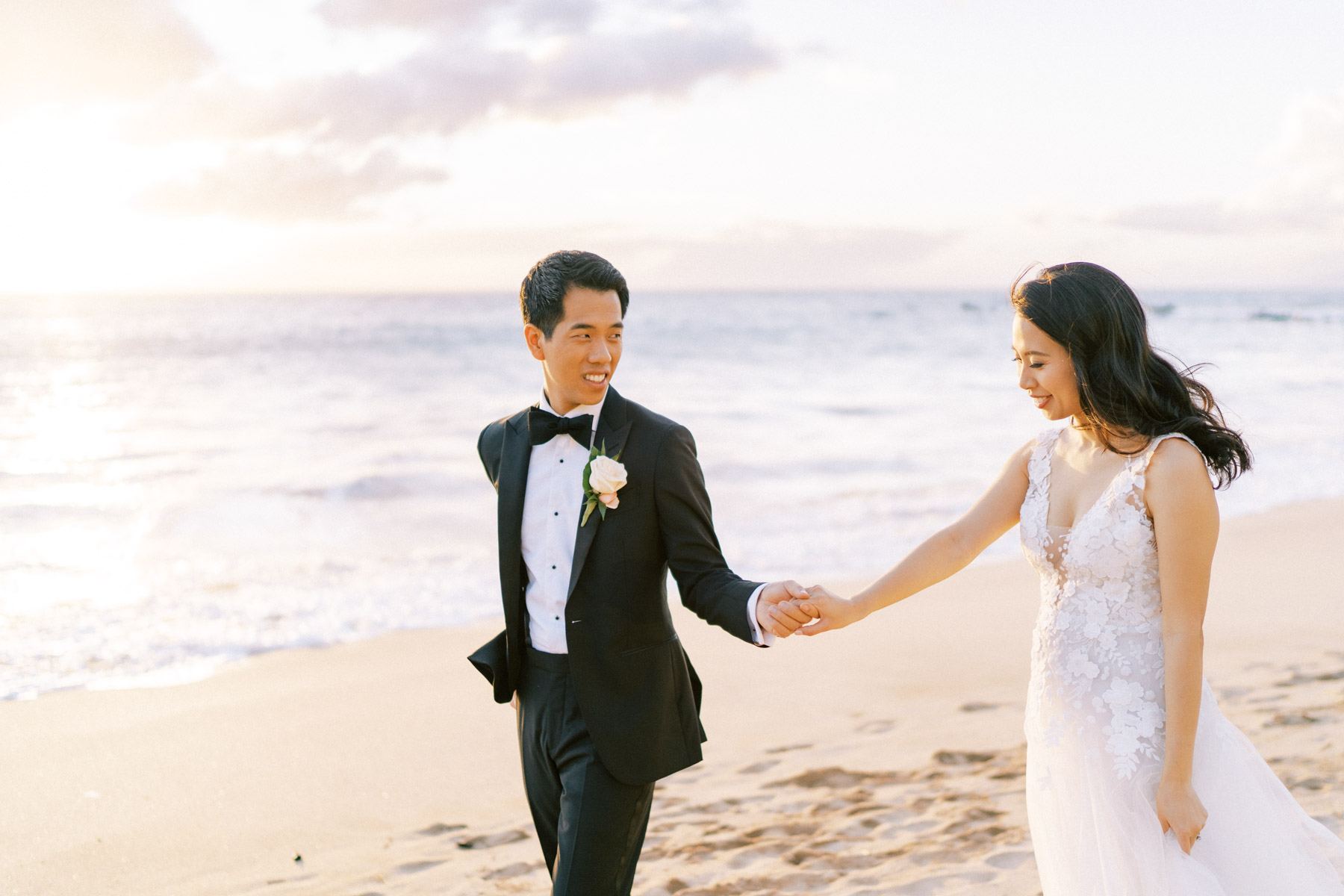 Newlyweds holding hands at the beach Wedding in Hotel Wailea