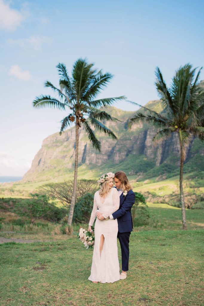 Groom hugging the bride from the back Kualoa Ranch Elopement
