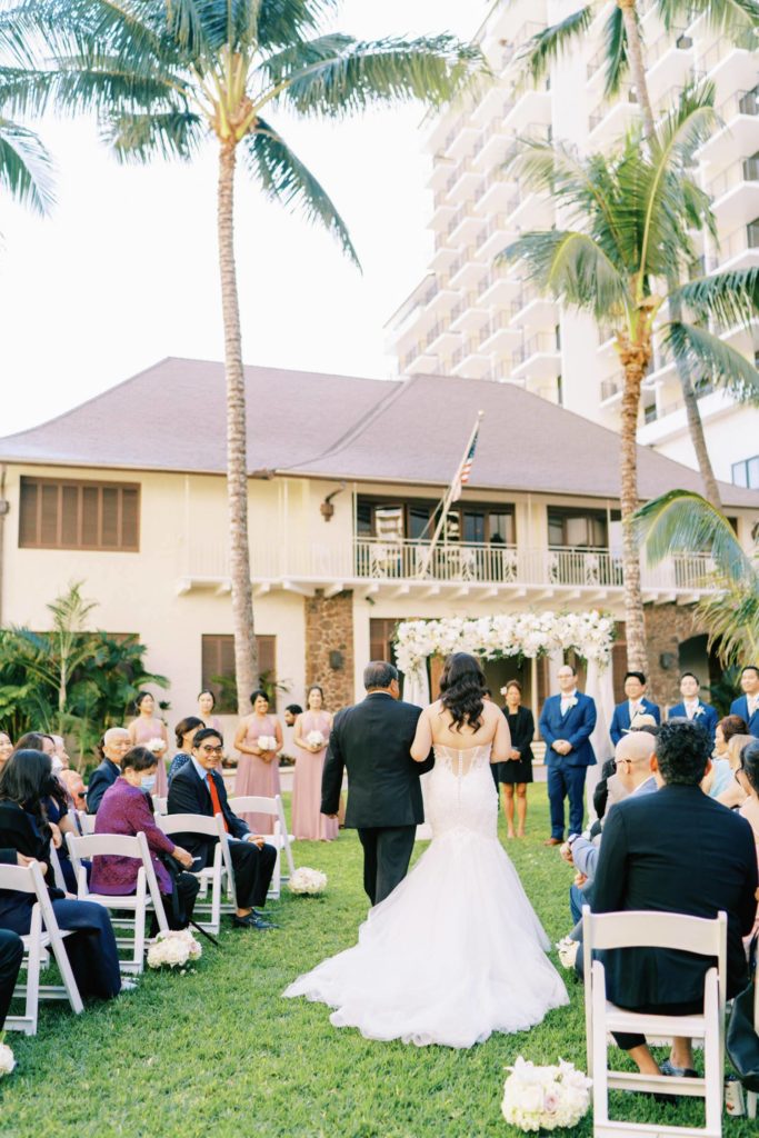 Bride walking down the aisle with her father at Oahu Wedding