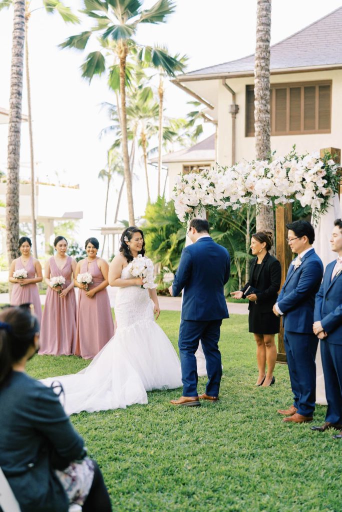 Bride smiling and facing the groom at Oahu Wedding