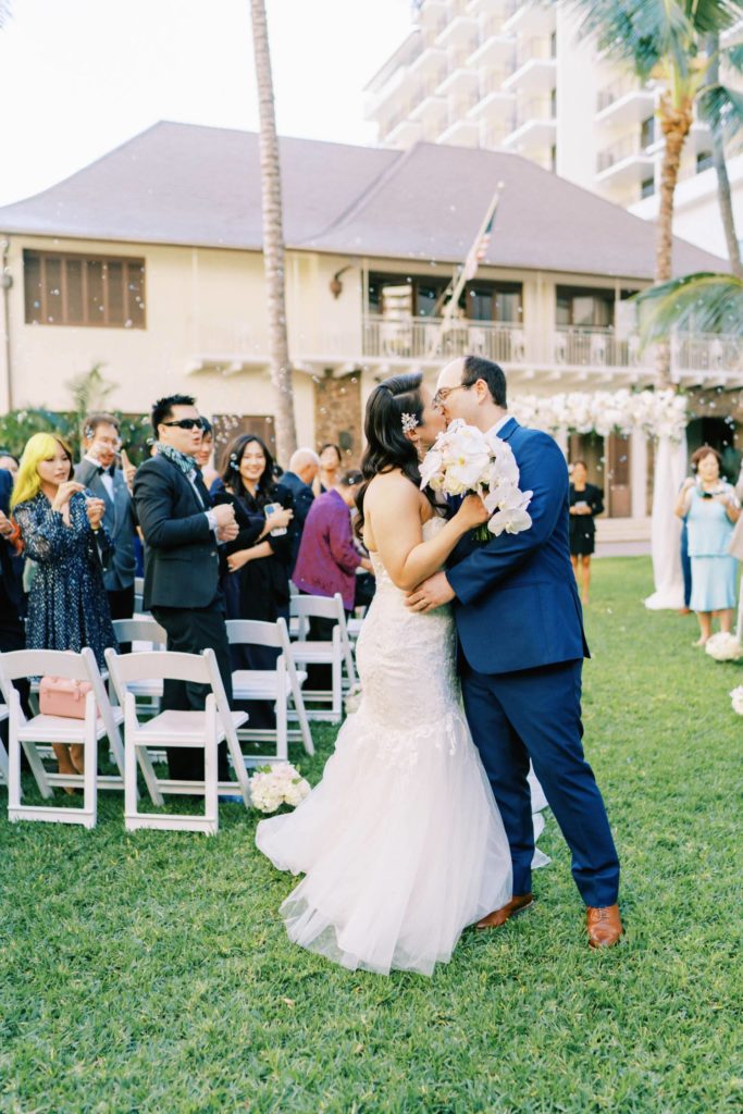 Newlyweds kiss at Oahu Wedding inThe Halekulani Hotel