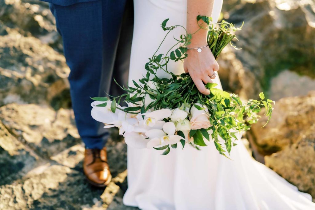 Bride holding a bouquet with the groom during elopement