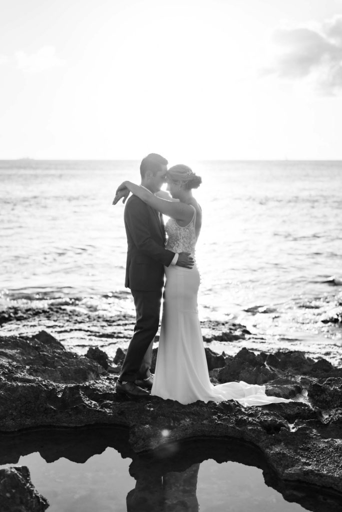 Black and White photo of Husband and Wife Intimate Oceanside Elopement on Oahu during sunset 