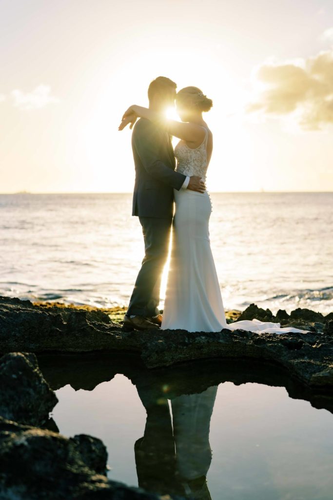 Husband and wife Intimate Oceanside Elopement on Oahu during sunset 