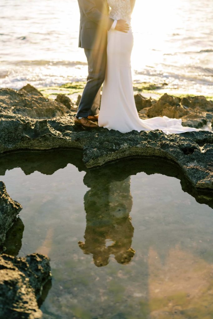 Newlyweds standing on the seashore Intimate Oceanside Elopement on Oahu