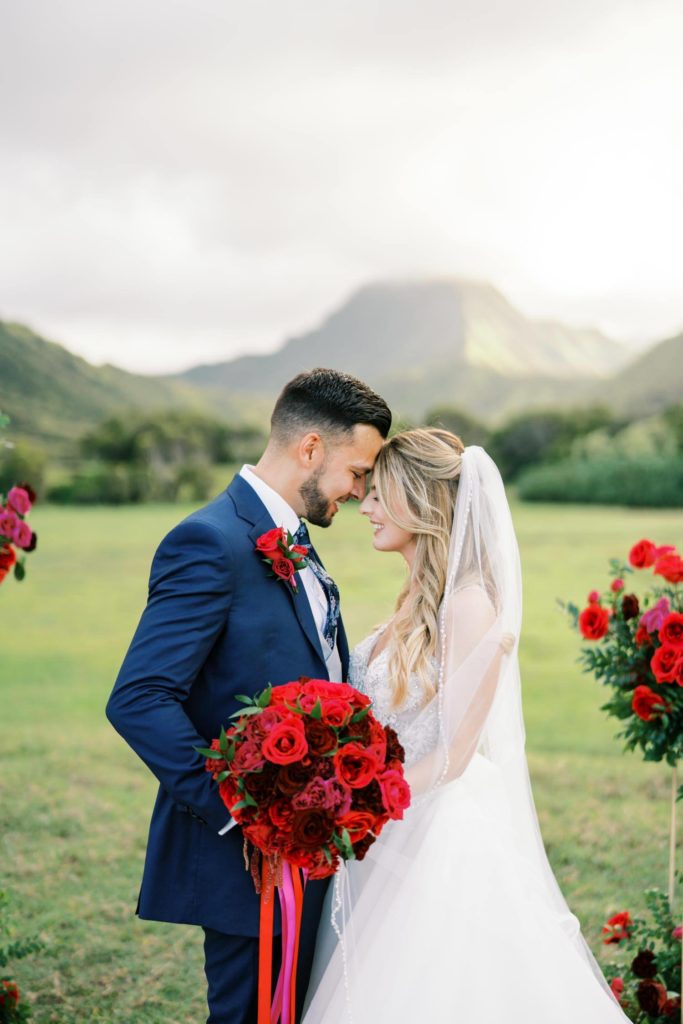 Bride and groom with their eyes closed Intimate Elopement at Kualoa Ranch on Oahu