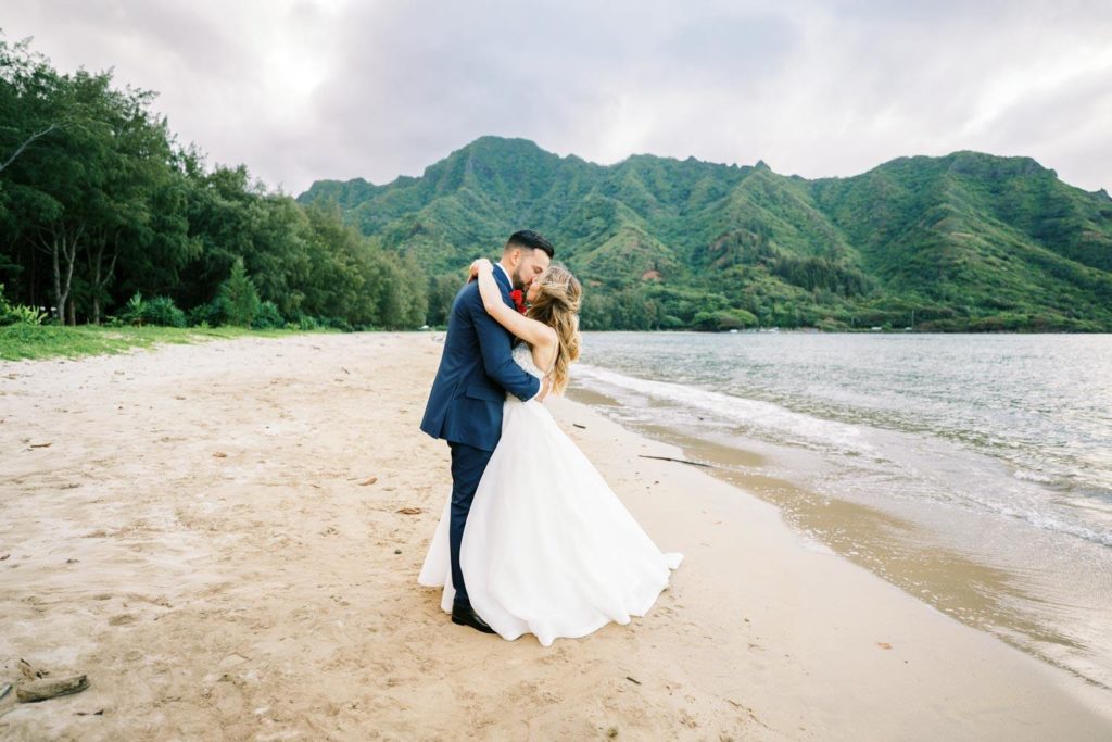 Newlyweds kissing by the beach 