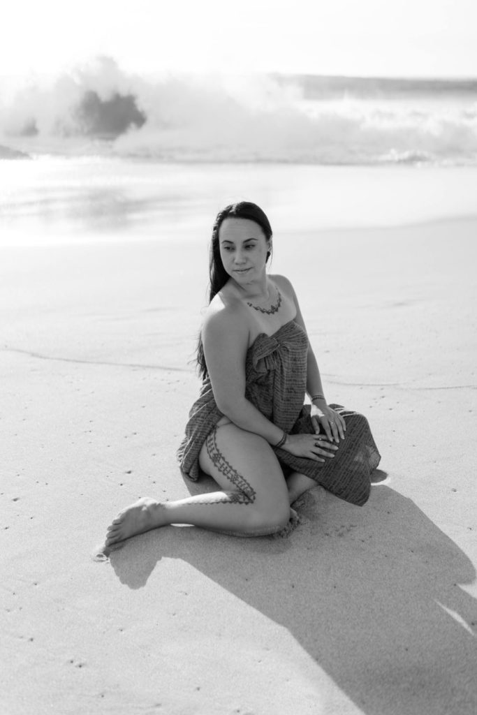 Black and white photo of a Personal Branding Session of a woman looking to the side sitting on the beach in Waianae Oahu Hawaiian Culture