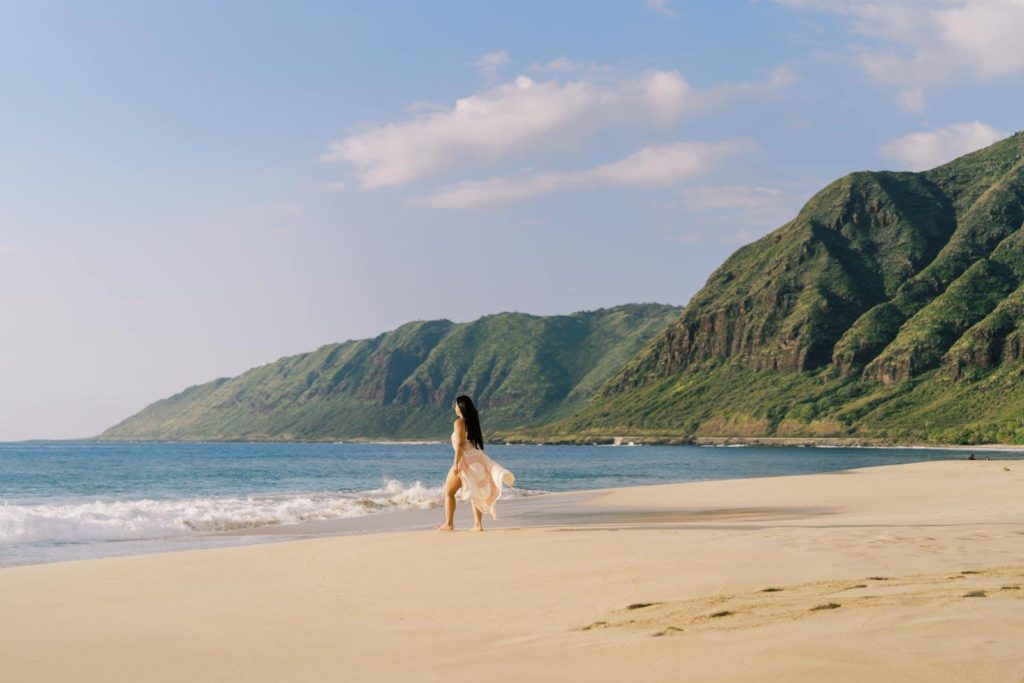 Personal Branding Session Woman in beautiful maxi dress walking towards the sea in Oahu beach