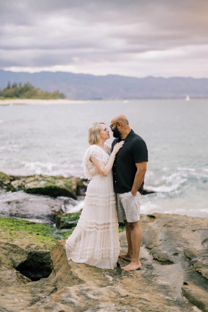 Husband and wife looking into each other's eyes at The North Shore of Oahu Papa'iloa Beach. 