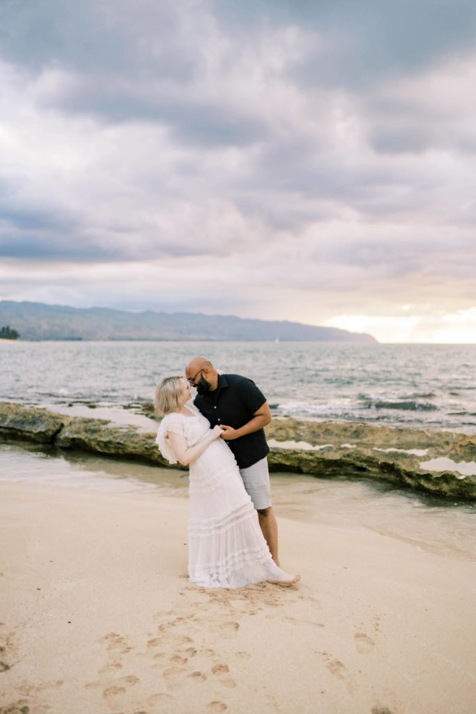 Couple kissing by the beach at The North Shore of Oahu