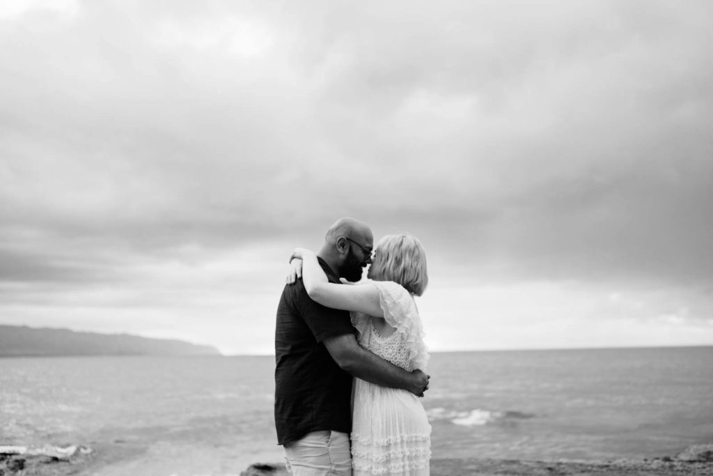 Black and white photo of husband and wife during a dreamy sunset session on the North Shore of Oahu.