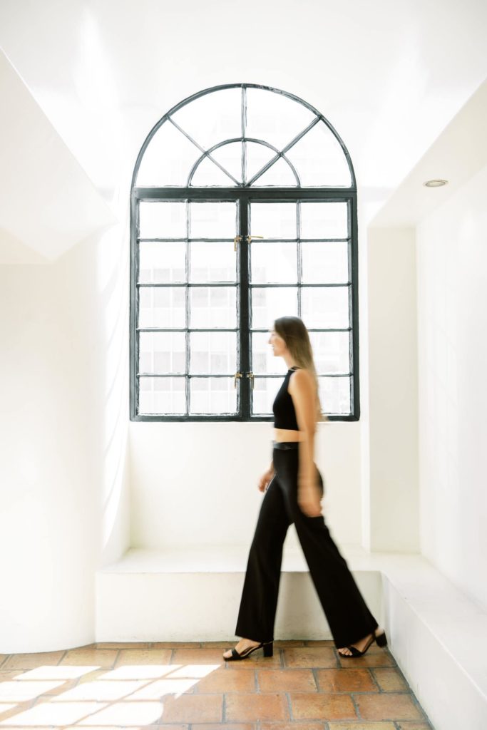 Blur photo of a woman walking by the window