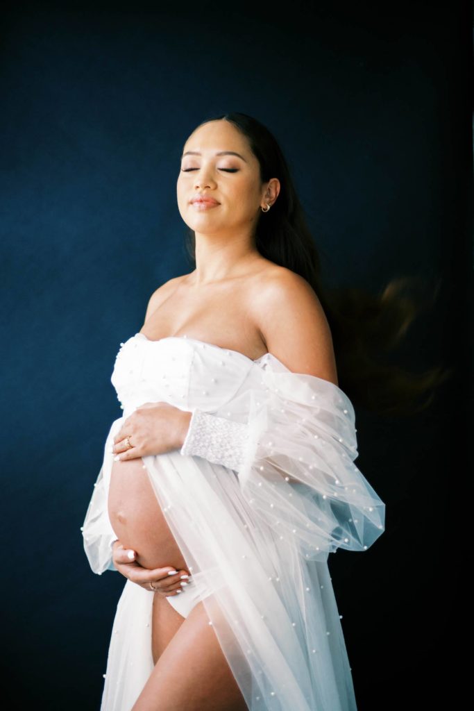 Pregnant woman holding her baby bump 
