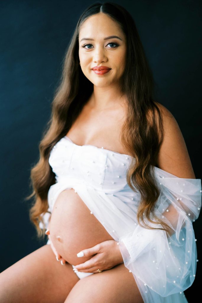 pregnant woman holding her baby bump