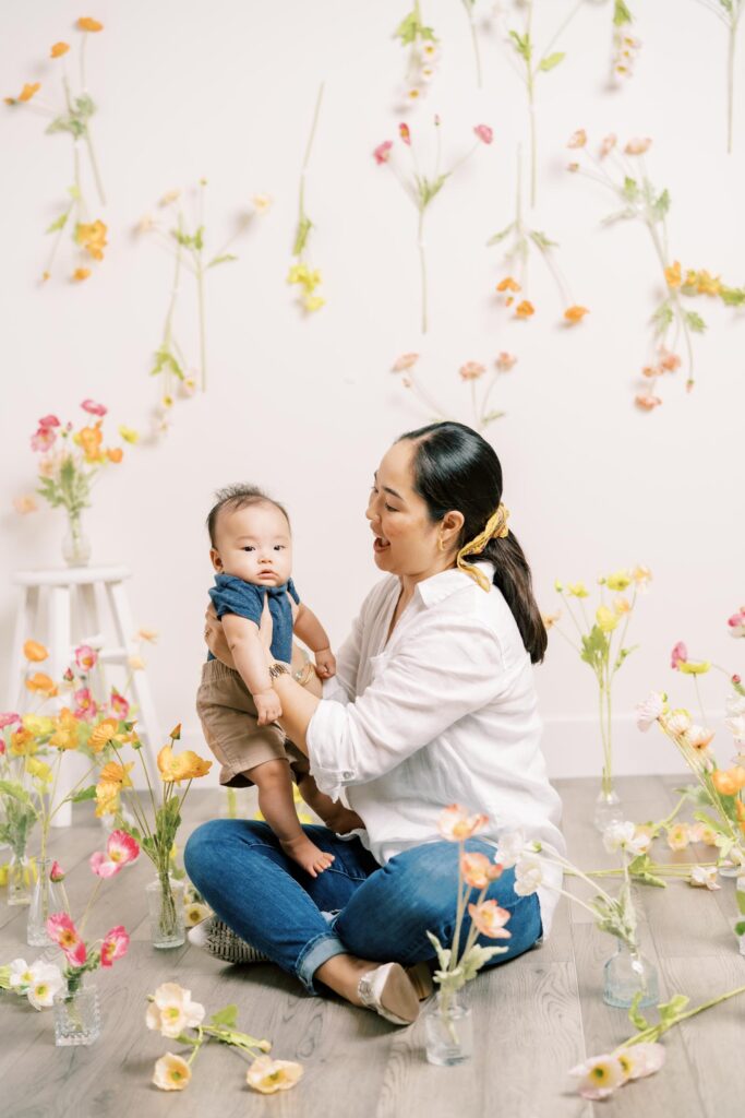 in studio portraits of mom and son with silk flowers