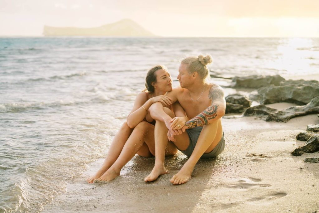Intimate photo of a couple at the beach during sunrise on Oahu