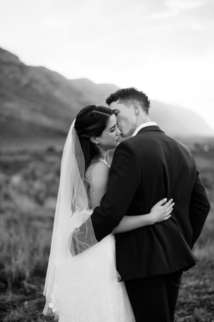 Black and White Photo of the Newlywed Couple kissing 