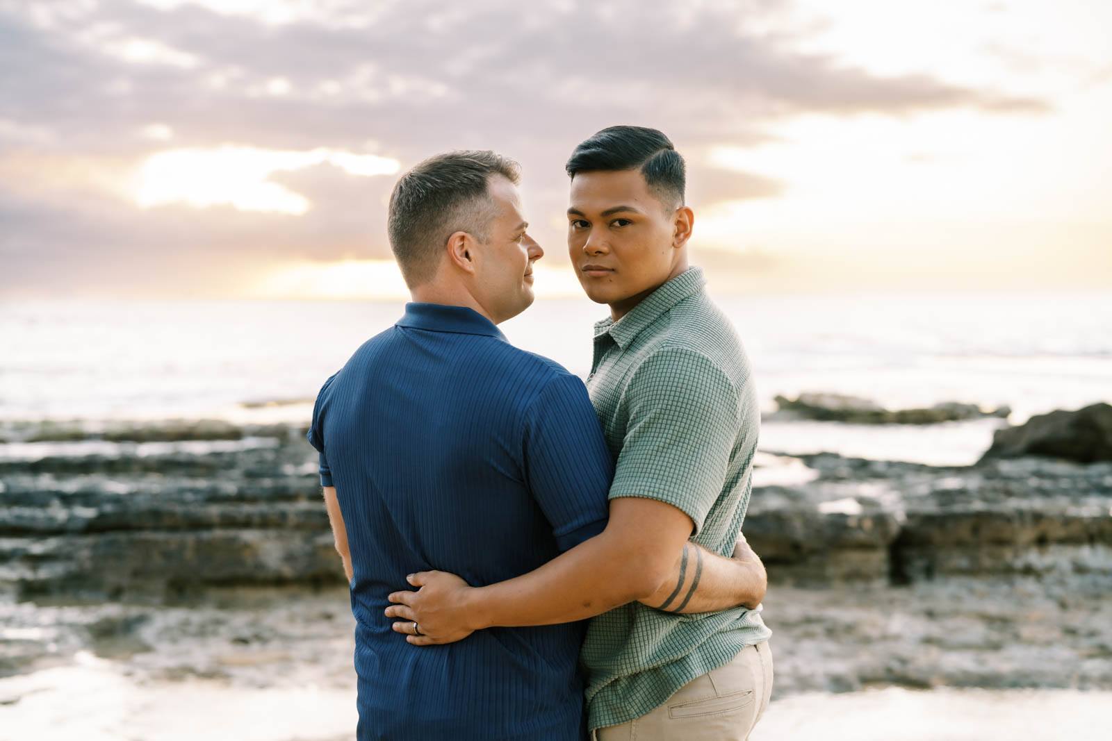 Oahu Engagement Session LGBTQ couple hugging during sunset on the Haleiwa Beach 