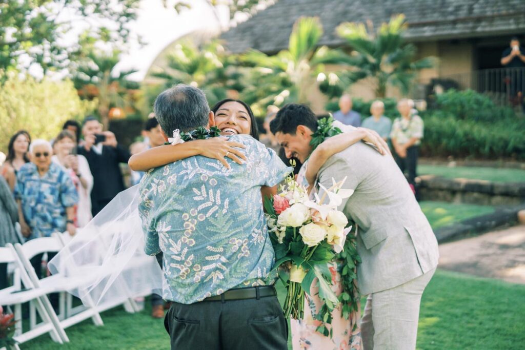 Newlyweds hugging their guests at the reception