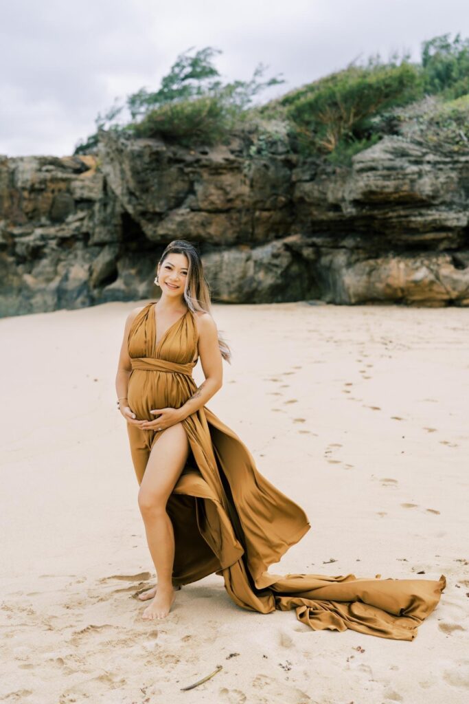 North Shore Maternity Photos of a pregnant woman wearing a brown dress at Laie beach