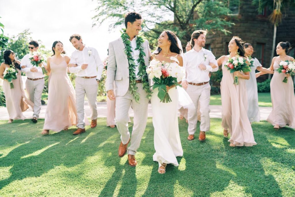 Newlyweds walking with their entourage at the Bishop Museum Honolulu