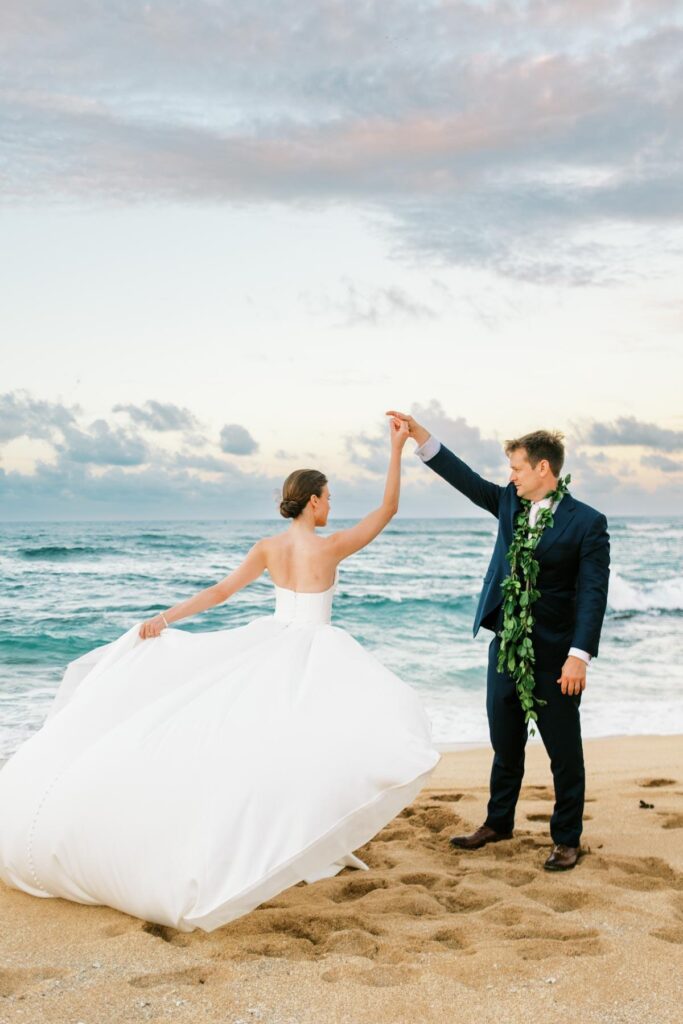 Newlyweds dancing at the Na Aina Kai beach Wedding on Kauai