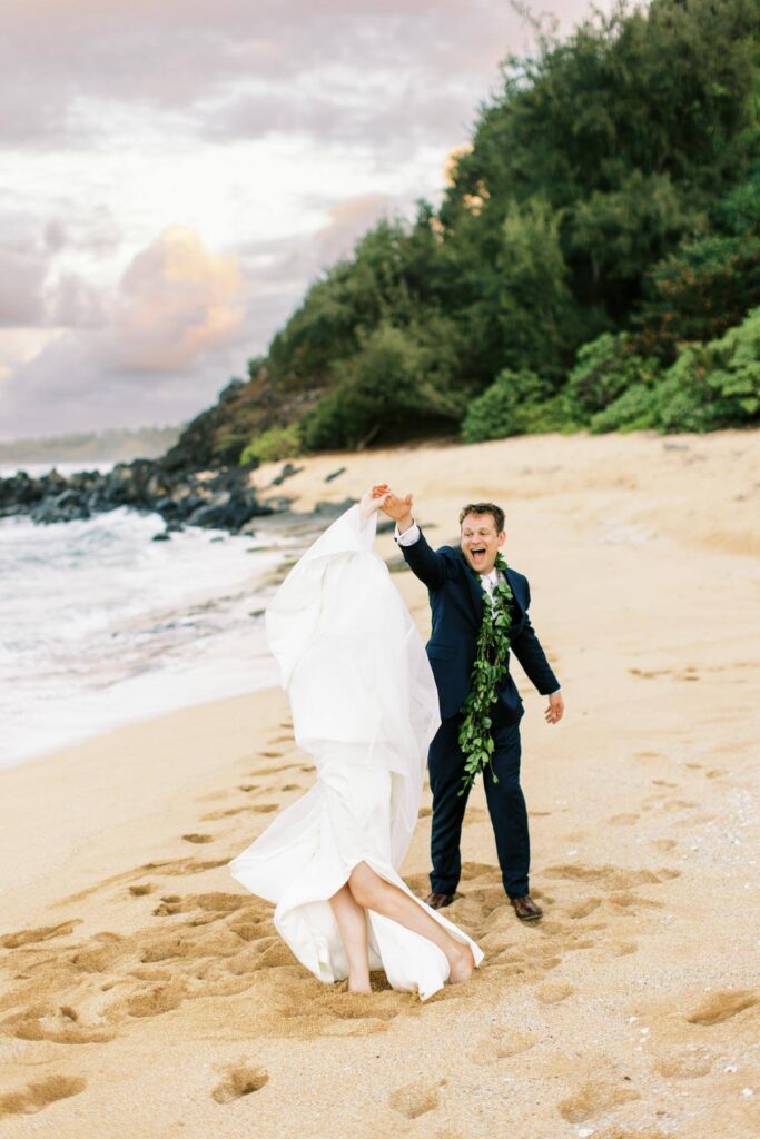 Newlyweds dancing at the Na Aina Kai beach
